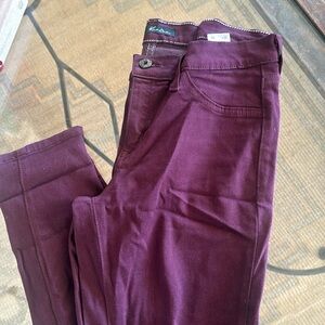 Kancan maroon jeans with distressed knees.